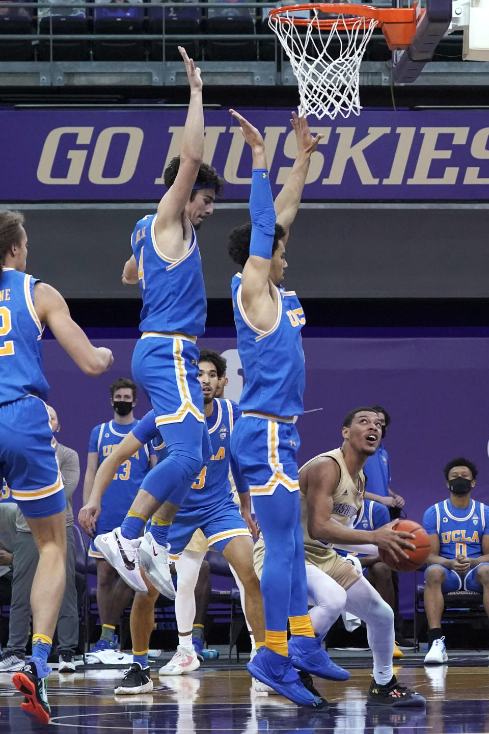Washington guard Quade Green, right, looks to shoot against UCLA guards Jaime Jaquez Jr., center left, and Jules Bernard, center right, during the first half of an NCAA college basketball game Saturday, Feb. 13, 2021, in Seattle. (AP Photo/Ted S. Warren)