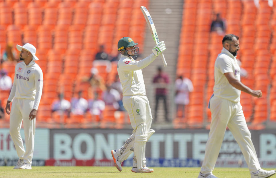 Australia's Usman Khawaja, center, raises his bat after scoring one hundred and fifty runs during the second day of the fourth cricket test match between India and Australia in Ahmedabad, India, Friday, March 10, 2023. (AP Photo/Ajit Solanki)