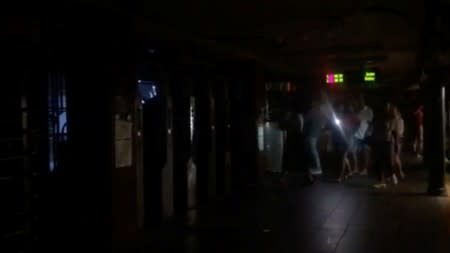 Passengers walk in the 66th Street subway station during a blackout caused by widespread power outages, in this still frame taken from video, in the Manhattan borough of New York City