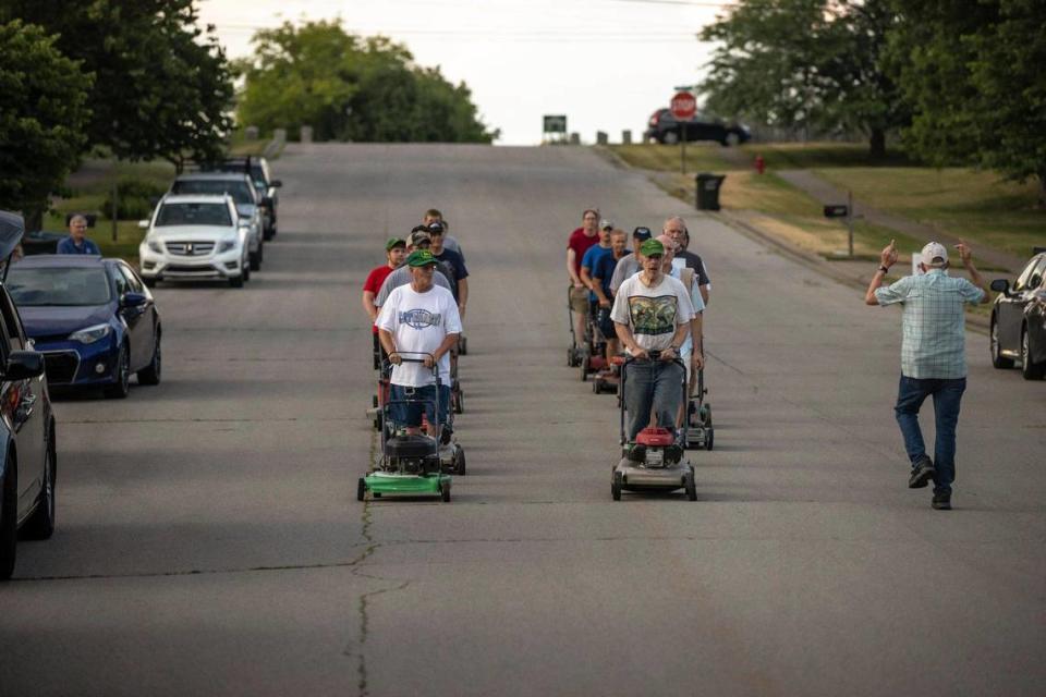 Glen Flanigan, right, Wilmore Lawnmower Brigade co-director, leads the group’s members in a practice session in Wilmore, Ky., on Thursday, June 30, 2022.