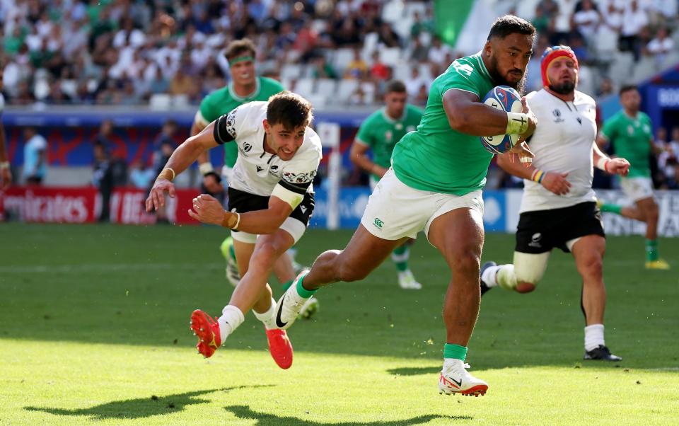 Bundee Aki of Ireland breaks through the Romania defence to score his side's eleventh try