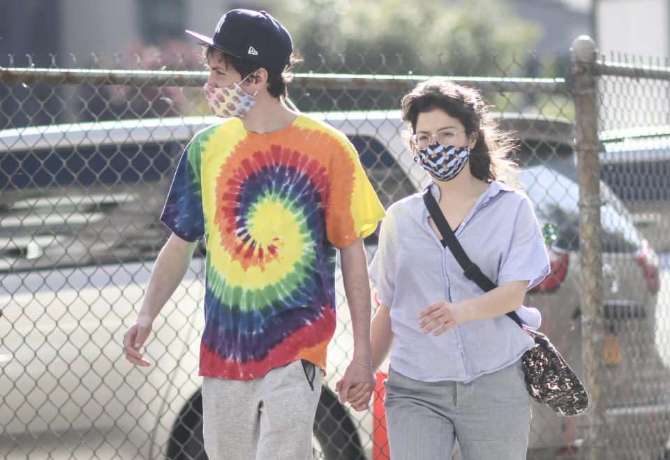 NEW YORK, NEW YORK - MAY 25: A couple is seen wearing a Larry David and a Judge Judy protective mask during the coronavirus pandemic on May 25, 2020 in Brooklyn, New York. (Photo by Daniel Zuchnik/Getty Images)