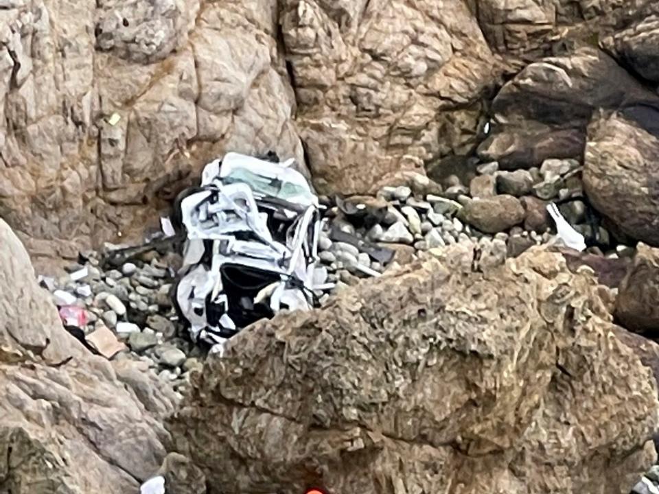 This image from video provided by San Mateo County Sheriff's Office shows a Tesla vehicle that plunged off a Northern California cliff along the Pacific Coast Highway, Monday, Jan. 2, 2023, near an area known as Devil's Slide, leaving four people in critical condition, a fire official said.