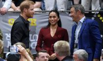 <p>Meghan looked relaxed and casual in a laid-back pair of jeans and a long-sleeved burgundy top by Australian designer Scanlan Theodore. She also wore a Remembrance Day poppy on the lapel of her top. Photo: AAP </p>