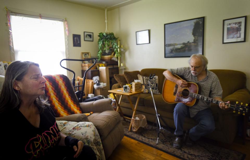 Husband-and-wife duo Tom Heideman and Mary Koenigsknecht sing in harmony as they perform the title track of Tom's newly-released five-song EP "Find a Better Way" at their home in Lansing, Monday, Aug. 7, 2023.  Heideman's newly-released song was written after the mass shooting at Michigan State University, and addresses the pervasiveness of gun violence in today's society.