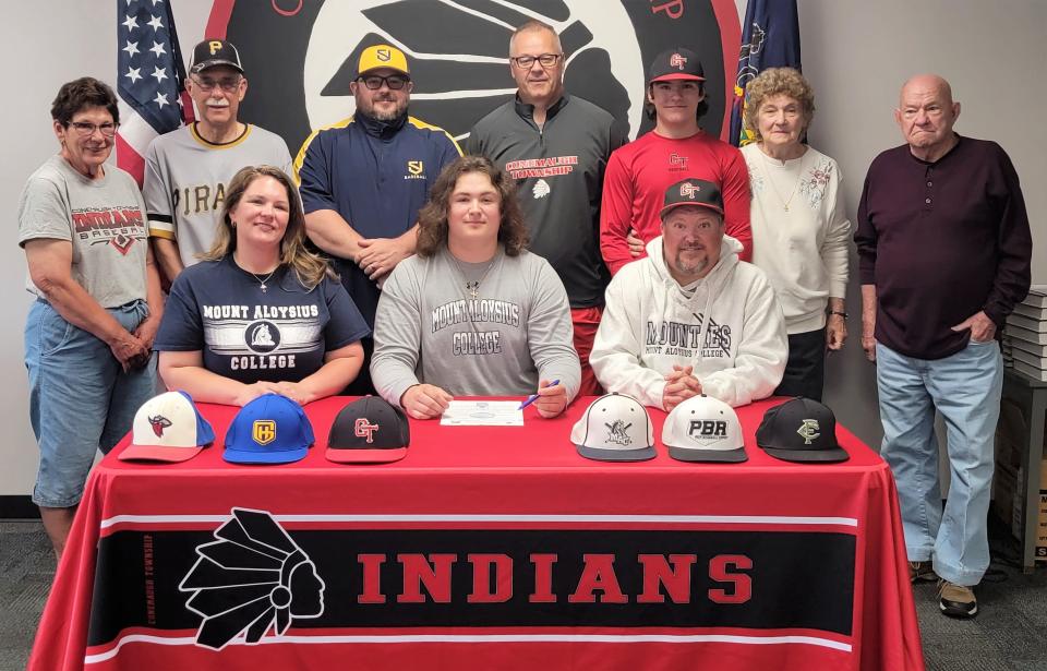 Flanked by parents Danyelle Baxter and Jason Weber, Conemaugh Township senior Tyler Weber announces his intentions to play baseball at Mount Aloysius College, May 23, in Davidsville. In back, from left, Weber's grandparents Diana and Bob Baxter, Weber's summer league coach Rusty Thomas, Conemaugh Township baseball coach Sam Zambanini, Weber's brother Luke Weber, and grandparents June and Jim Weber.