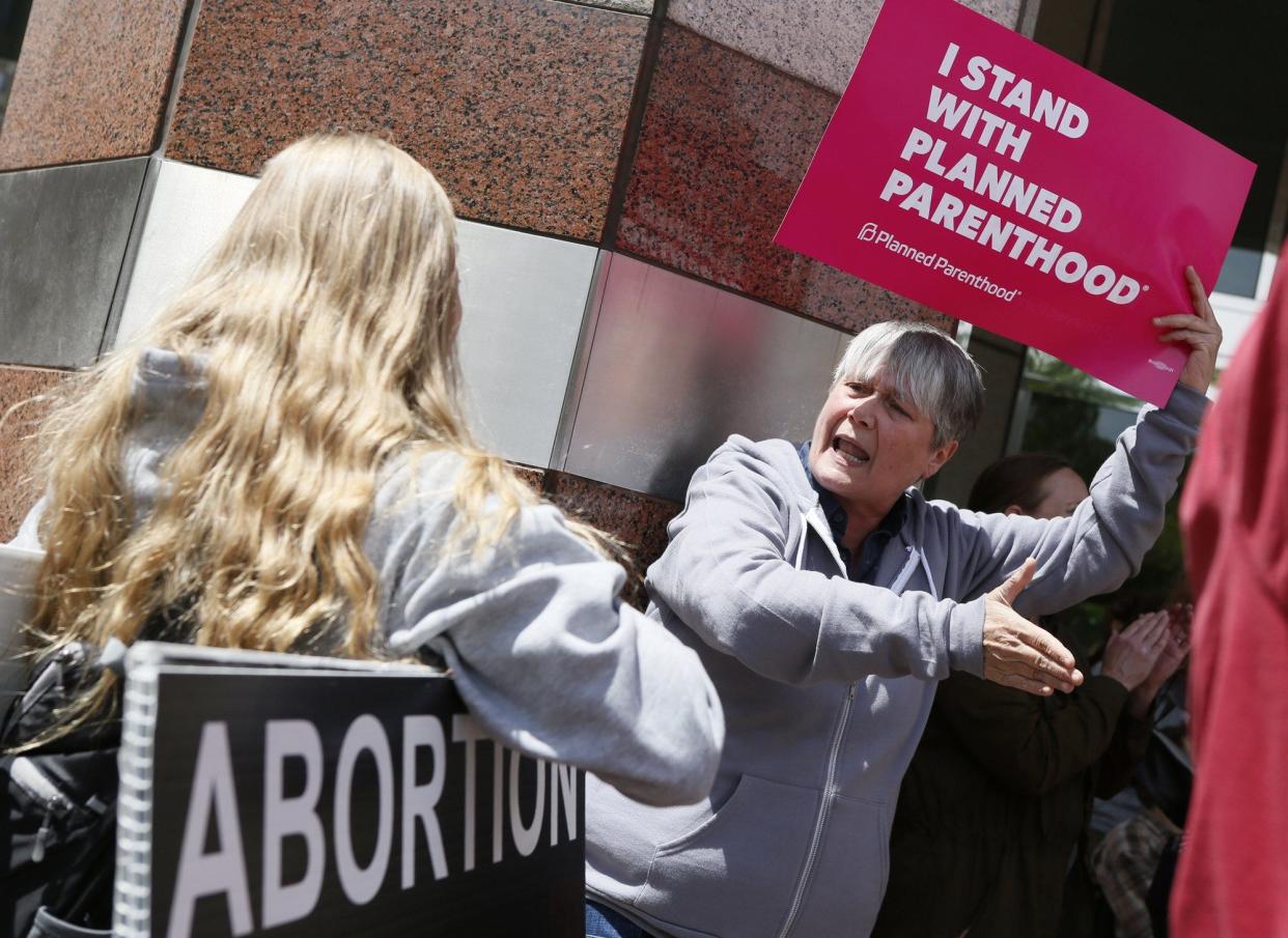 Mary Dillon, a pro choice protester, argues with anti abortion protester Evangeline Dunn at A Stop The Bans protest at the Riffe Center on May 21, 2019. [Dispatch file photo]