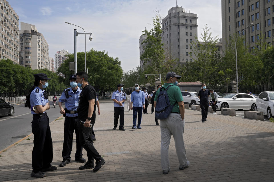 Uniform and plain clothes policemen patrol near the No. 2 Intermediate People's Court where the espionage charges case for Yang Hengjun is going to be held in Beijing, Thursday, May 27, 2021. Australian ambassador to China Graham Fletcher said it was “regrettable” that the embassy was denied access Thursday as a trial was due to start for Yang, a Chinese Australian man charged with espionage. (AP Photo/Andy Wong)