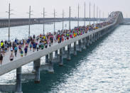 In this photo provided by the Florida Keys News Bureau, a portion of the field of 1,500 competitors approaches the "hump" of the Seven Mile Bridge in the Florida Keys while competing in the annual Seven Mile Bridge Run Saturday, April 1, 2023, near Marathon, Fla. Joanna Stephens, 28, of Atlanta won the overall women's title and Vaclav Bursa, 15, of Big Pine Key, Fla., won the overall men's division. (Andy Newman/Florida Keys News Bureau via AP)