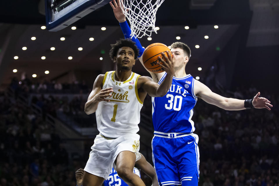 Notre Dame's Julian Roper II (1) drives past Duke's Kyle Filipowski (30) during the second half of an NCAA college basketball game Saturday, Jan. 6, 2024, in South Bend, Ind. (AP Photo/Michael Caterina)