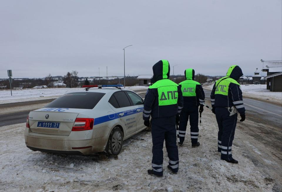 Traffic police officers block off a road near the crash site of the Russian Ilyushin Il-76 military transport plane in Belgorod region (REUTERS)