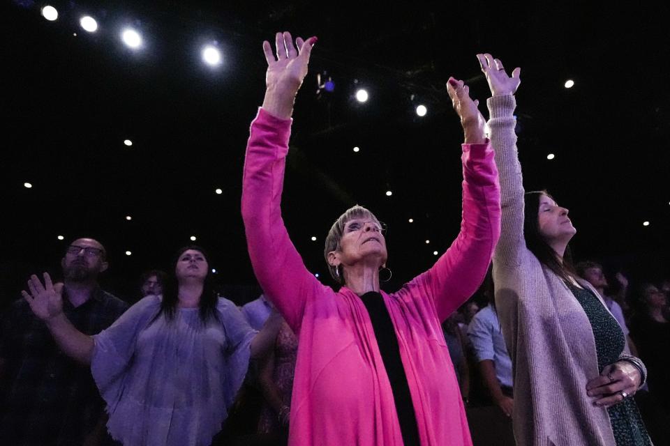 A member prays during a Sunday service at Bethlehem Church, Sunday, Sept. 8, 2024, in Bethlehem, Ga. Colt Gray, 14, has been charged with murder over the killing of two students and two teachers at Apalachee High School in Barrow County, outside Atlanta, on Wednesday. (AP Photo/Mike Stewart)