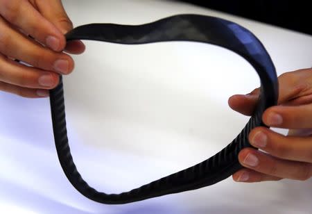 Industrial designer Braden Wilson holds a protype of a device called a "Brainband" during a demonstration of the thick black headband in Sydney, Australia, March 22, 2016. REUTERS/David Gray