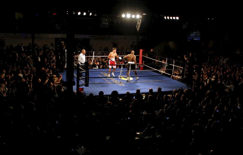 Former Massachusetts Governor and two-time presidential candidate Mitt Romney fights five-time heavyweight champion Evander Holyfield during their boxing match in Salt Lake City, Utah