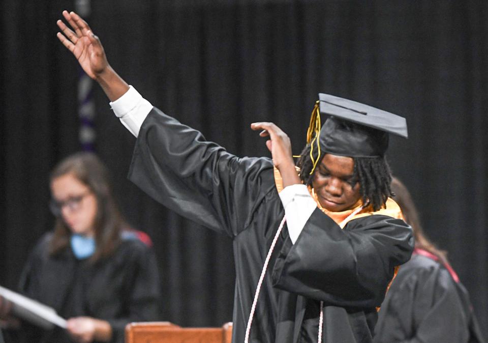 Joshua Christian Speaks dabs as he walks up to get his diploma during the 2024 ceremony for Pendleton High School in Littlejohn Coliseum in Clemson, S.C. Tuesday, May 21, 2024.