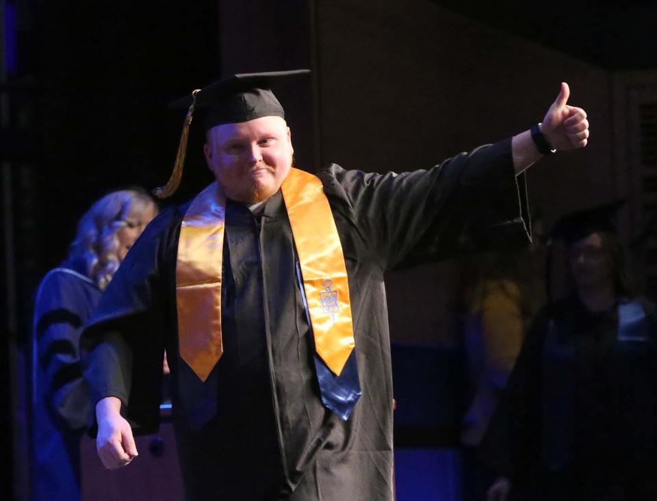Graduates cross the stage and show off their diplomas during the 27th annual commencement address for York County Community College May 13, 2022.