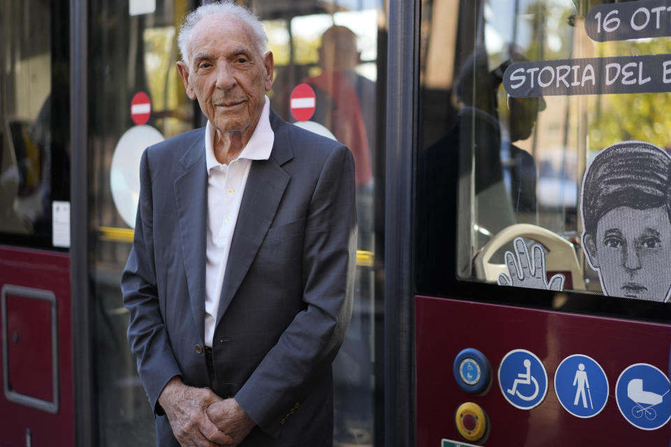 Emanuele Di Porto, 92, stands in front of a bus of the No. 23 route during the inaugurating of a traveling exhibit recounting his story, in Rome, Tuesday, Oct. 10, 2023. Di Porto, at the time a 12 years old Roman Jew, hid on a tram for a few days from Nazi deportation in October 1943, with drivers feeding him and helping him.The traveling exhibit is a highlight of events commemorating the 80th anniversary of the roundup of some 1,200 of the city's tiny Jewish community by German soldiers during the Nazi occupation in the latter years of World War II. (AP Photo/Andrew Medichini)