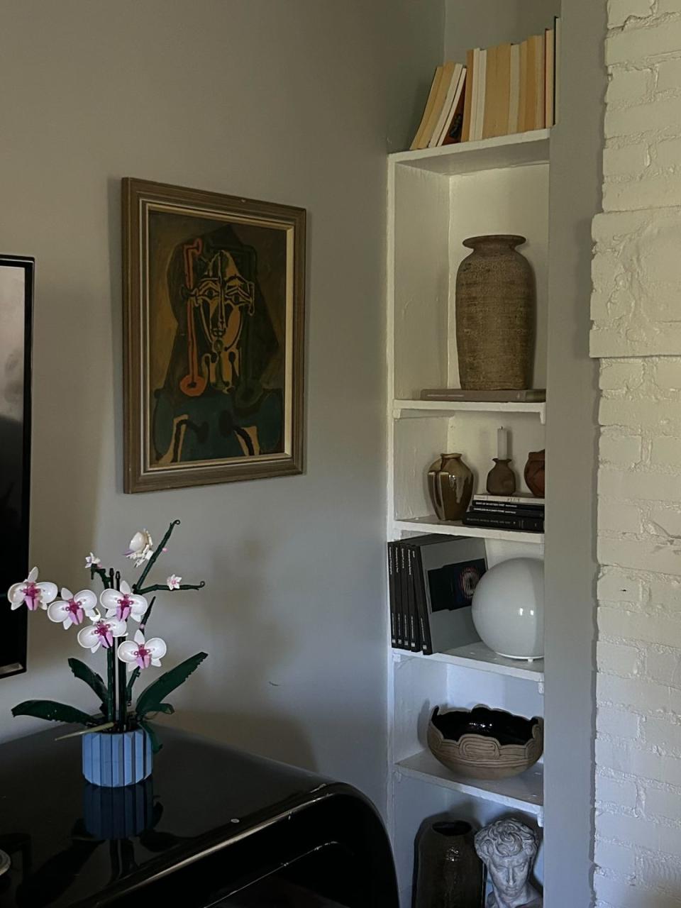 a vase of flowers sits on a shelf