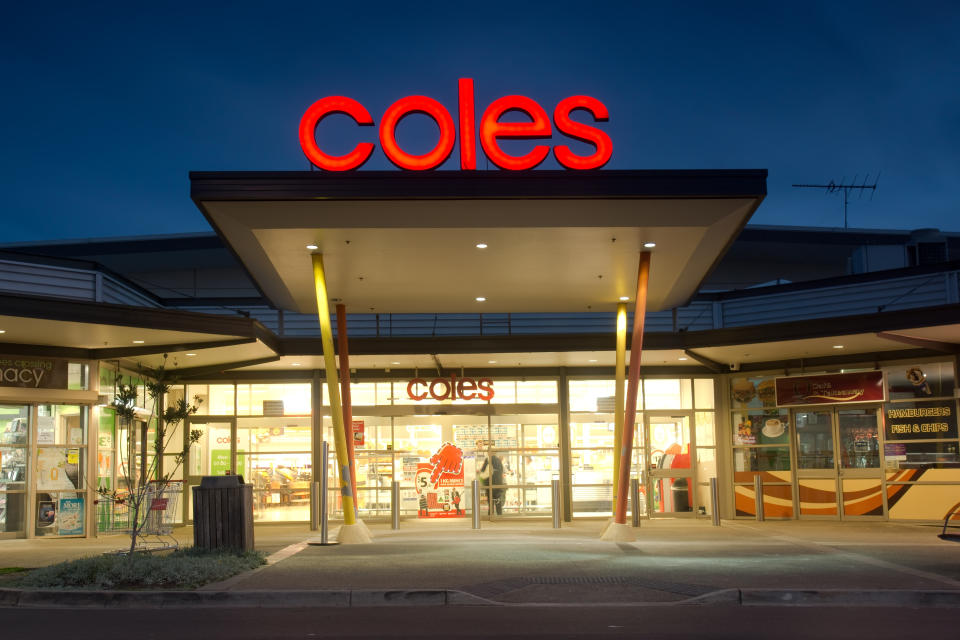 The entrance to a brightly lit Coles supermarket in Ropes Crossing at dusk