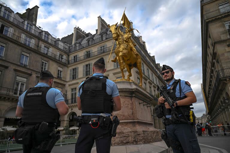 Agentes de policía patrullan una zona de seguridad alrededor de la estatua de Juana de Arco en la calle Rivoli, antes de los Juegos Olímpicos de París 2024 en París el 22 de julio de 2024