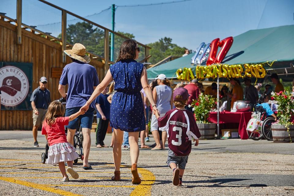 In 2021, fans enter Lowell Park in Cotuit for a Cape Cod Baseball League game.