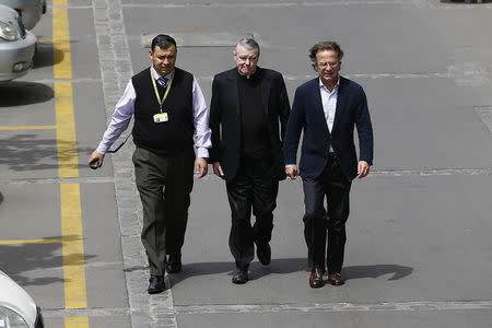 FILE PHOTO: Irish-born Chilean priest John O'Reilly (C) of the Legionaries of Christ leaves from a court in Santiago, October 15, 2014. REUTERS/Ivan Alvarado