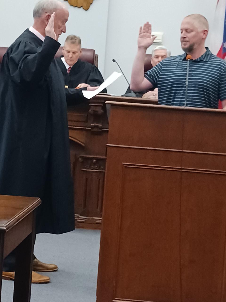 Cory Johnson (right) at his swearing-in ceremony with Judge John Nicholson. Johnson will replace outgoing auditor Tony Brown.