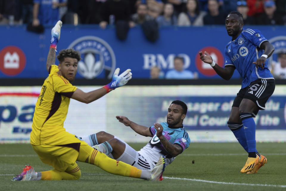 CF Montreal defender Zachary Brault-Guillard, right, watches his shot go past diving Minnesota United goalkeeper Dayne St. Clair, left, as Minnesota United defender D.J. Taylor, center, attempts a tackle during first-half MLS soccer match action in Montreal, Saturday, June 10, 2023. (Evan Buhler/The Canadian Press via AP)