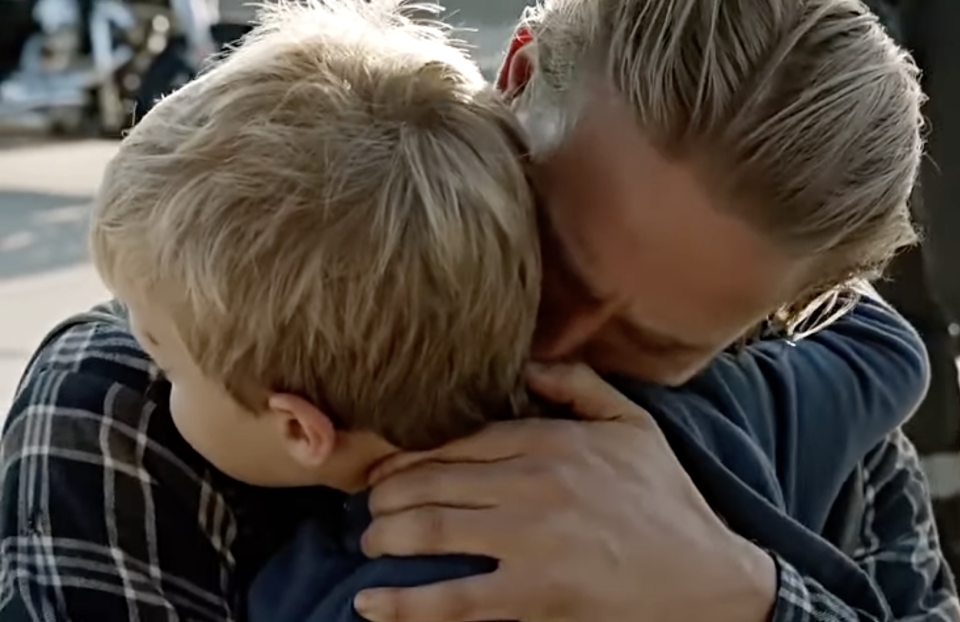 Charlie Hunnam as Jax Teller in "Sons of Anarchy" hugging his son Abel