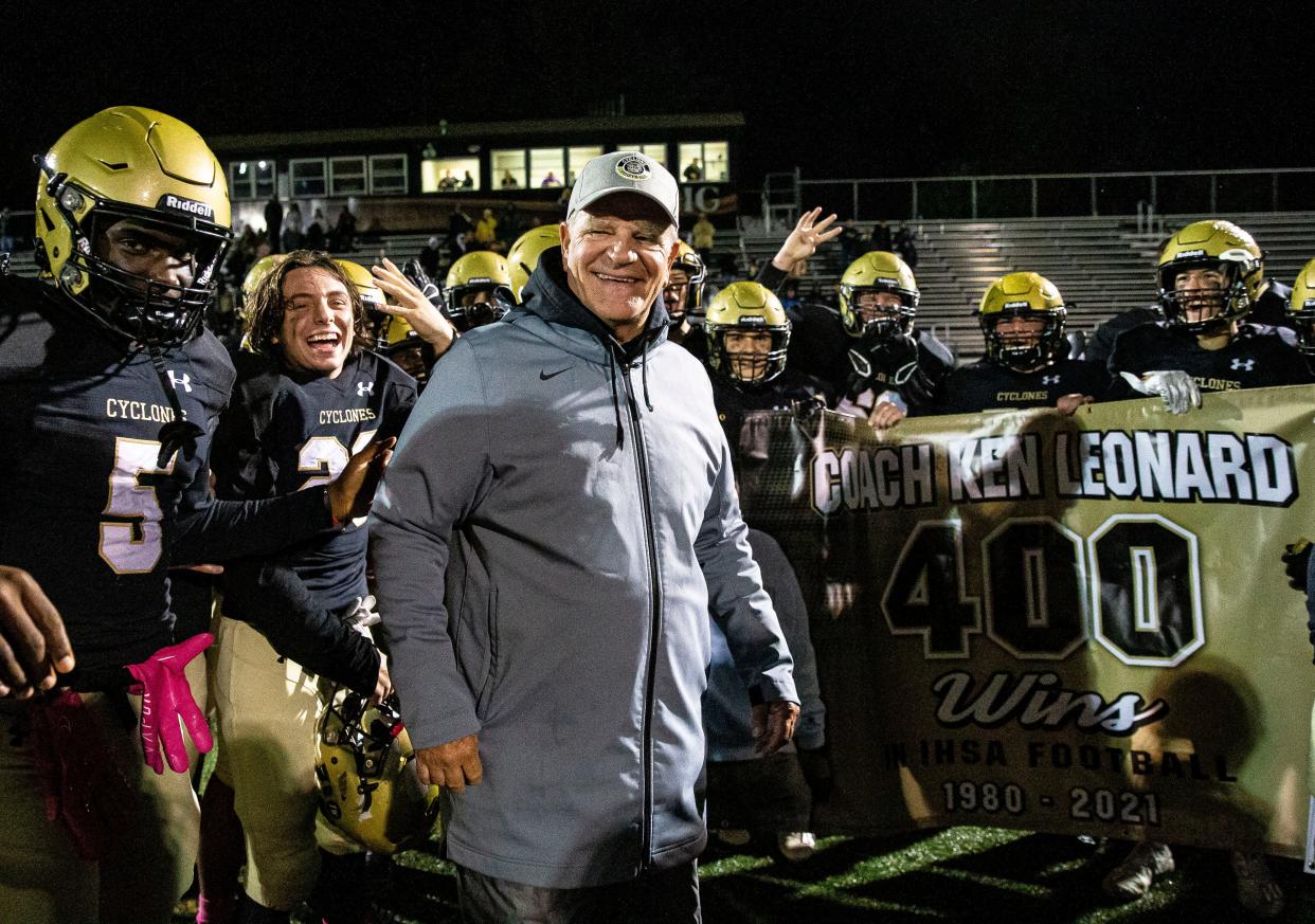 Sacred Heart-Griffin head football coach Ken Leonard is presented with a banner after the Cyclones defeated Normal U-High 49-6 for Leonard’s 400th win in 2021. Leonard is now a Capital Township trustee.