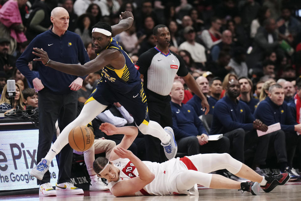 Indiana Pacers forward Pascal Siakam, top, jumps over Toronto Raptors forward Kelly Olynyk (41) during the first half of an NBA basketball game, Tuesday, April 9, 2024 in Toronto.(Nathan Denette/The Canadian Press via AP)