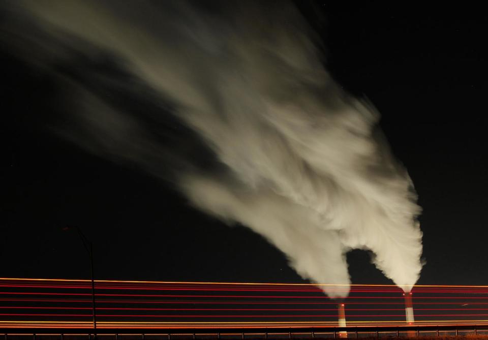 FILE - In this Jan. 19, 2012 file photo, smoke rises in this time exposure image from the stacks of the La Cygne Generating Station coal-fired power plant in La Cygne, Kan. The United Nations climate chief is urging people not to look solely to their governments to make tough decisions to slow global warming, and instead to consider their own role in solving the problem. Approaching the half-way point of two-week climate talks in Doha, Christiana Figueres, the head of the U.N.'s climate change secretariat, said Friday, Nov. 30, 2012 that she didn't see "much public interest, support, for governments to take on more ambitious and more courageous decisions."(AP Photo/Charlie Riedel, File)