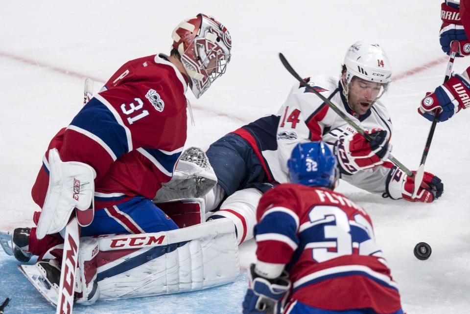 Washington Capitals right wing Justin Williams (14) can't get to the puck in front of Montreal Canadiens goalie Carey Price (31) during the second period of an NHL hockey game Monday, Jan. 9, 2017, in Montreal. (Paul Chiasson/The Canadian Press via AP)