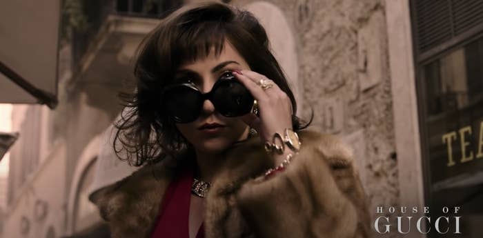 Patrizia lowering her sunglasses in "House of Gucci"