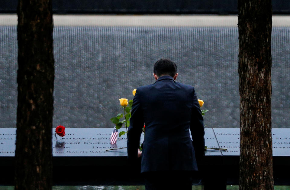 <p>A guest pauses at among names at the edge of the north reflecting pool at the National 9/11 Memorial and Museum during ceremonies marking the 17th anniversary of the September 11, 2001 attacks on the World Trade Center in New York, Sept.11, 2018. (Photo: Brendan McDermid/Reuters) </p>