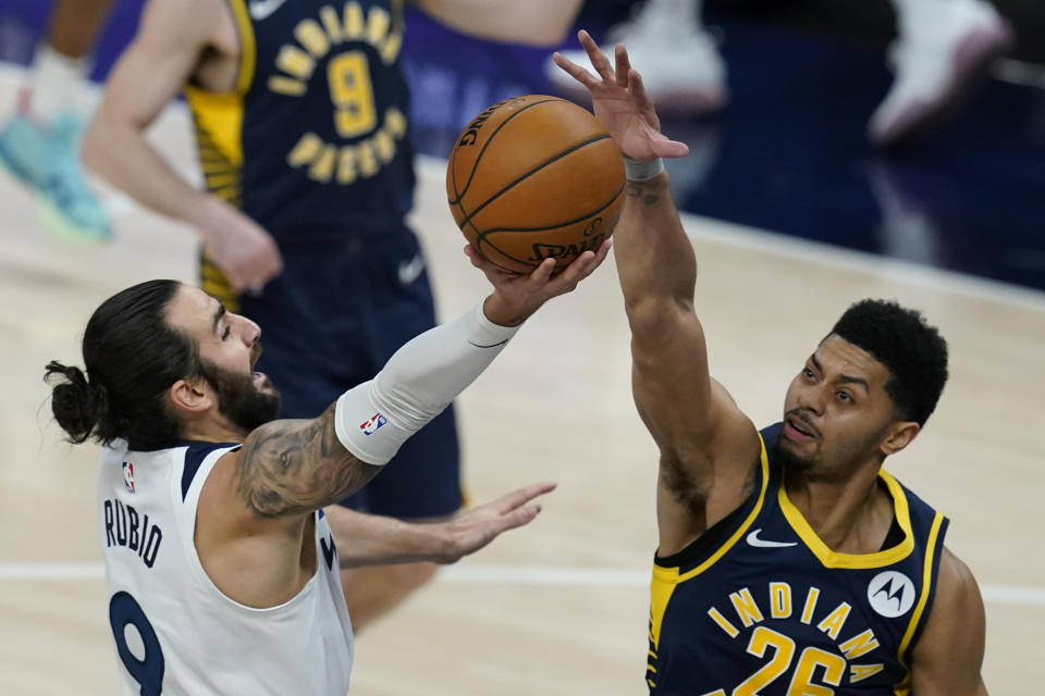 Minnesota Timberwolves' Ricky Rubio (9) has his shot blocked by Indiana Pacers' Jeremy Lamb (26) during the first half of an NBA basketball game, Wednesday, April 7, 2021, in Indianapolis. (AP Photo/Darron Cummings)