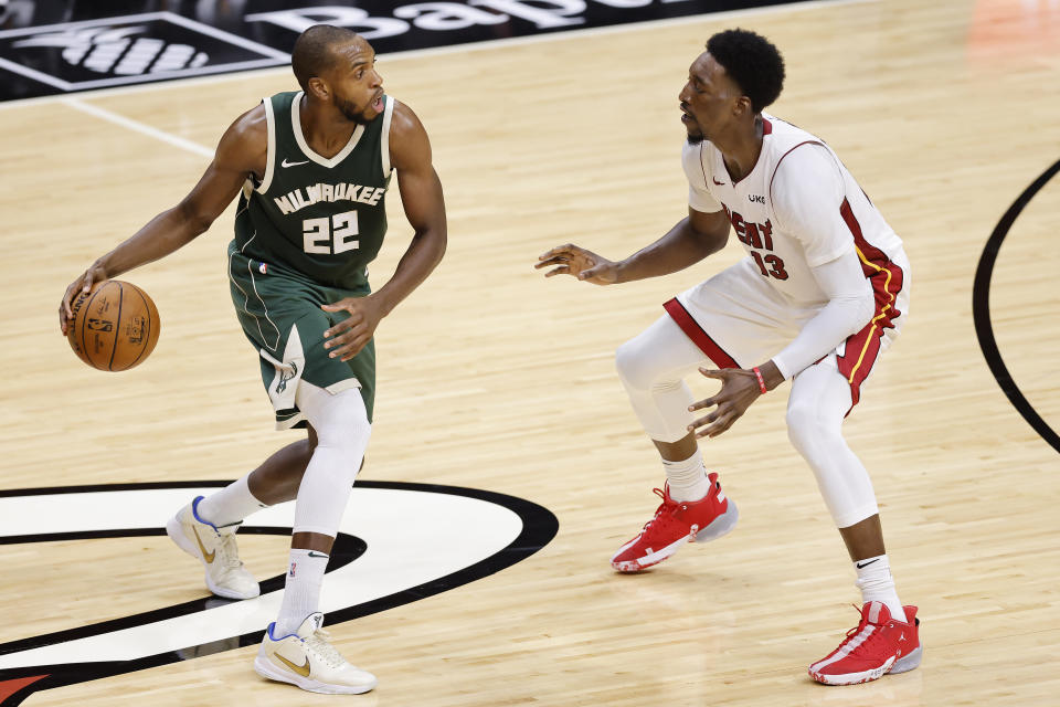 Khris Middleton #22 of the Milwaukee Bucks is defended by Bam Adebayo #13 of the Miami Heat during the second quarter at American Airlines Arena on December 30, 2020 in Miami, Florida. NOTE TO USER: User expressly acknowledges and agrees that, by downloading and or using this photograph, User is consenting to the terms and conditions of the Getty Images License Agreement. (Photo by Michael Reaves/Getty Images)