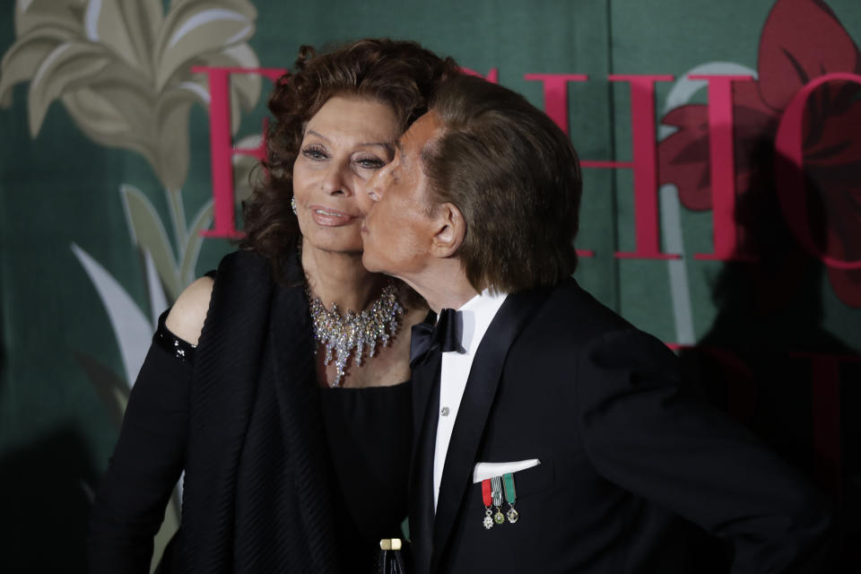 Designer Valentino Garavani, right, kisses actress Sophia Loren upon arrival at the Green Carpet Fashion Awards in Milan, Italy, Sunday, Sept. 22, 2019. (AP Photo/Luca Bruno)