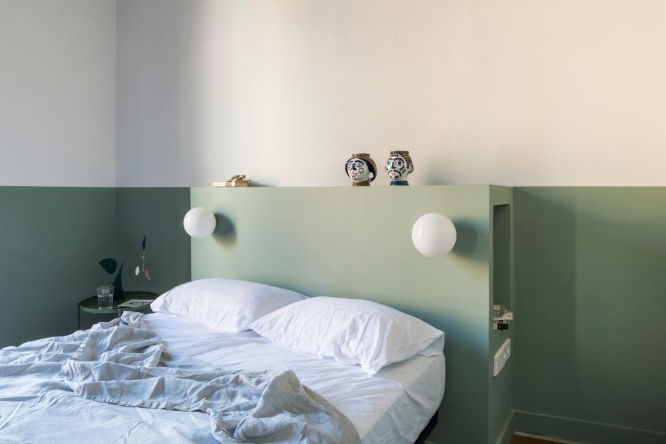 In the master bedroom, a clever storage nook was built in the custom headboard.