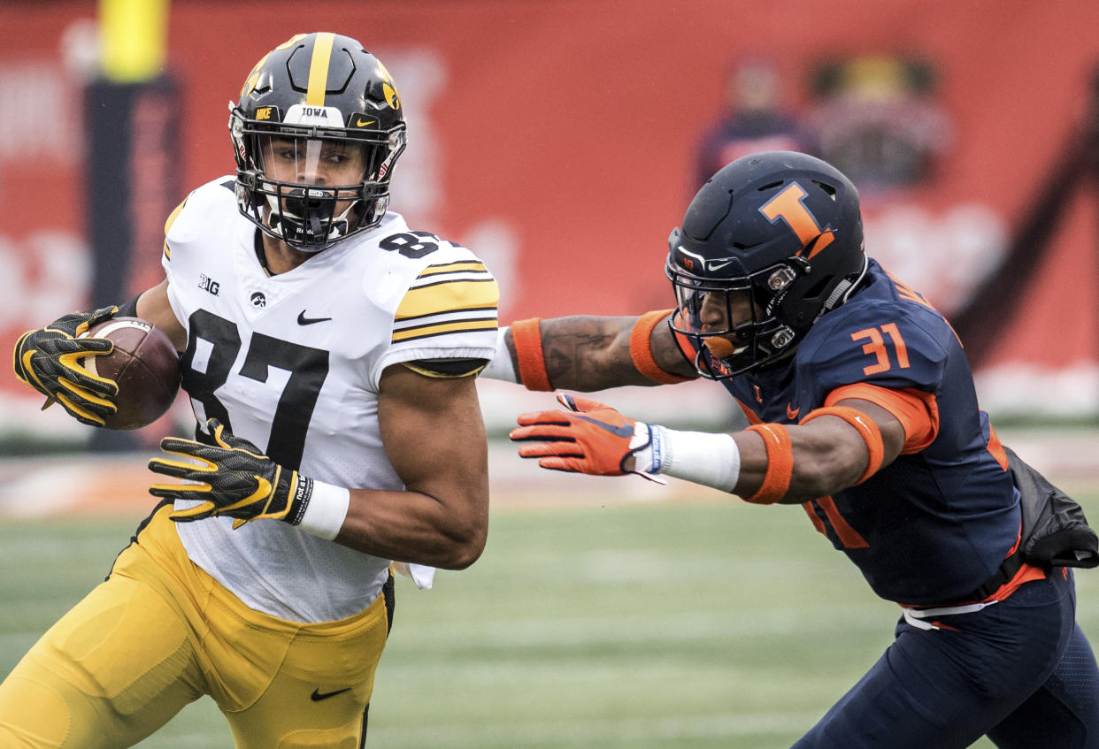 Iowa's Noah Fant (87) runs the ball after making a reception as Illinois' Cameron Watkins (31) attempts the tackle in the first half of a NCAA college football game, Saturday, Nov. 17, 2018, in Champaign, Ill. (AP Photo/Holly Hart)