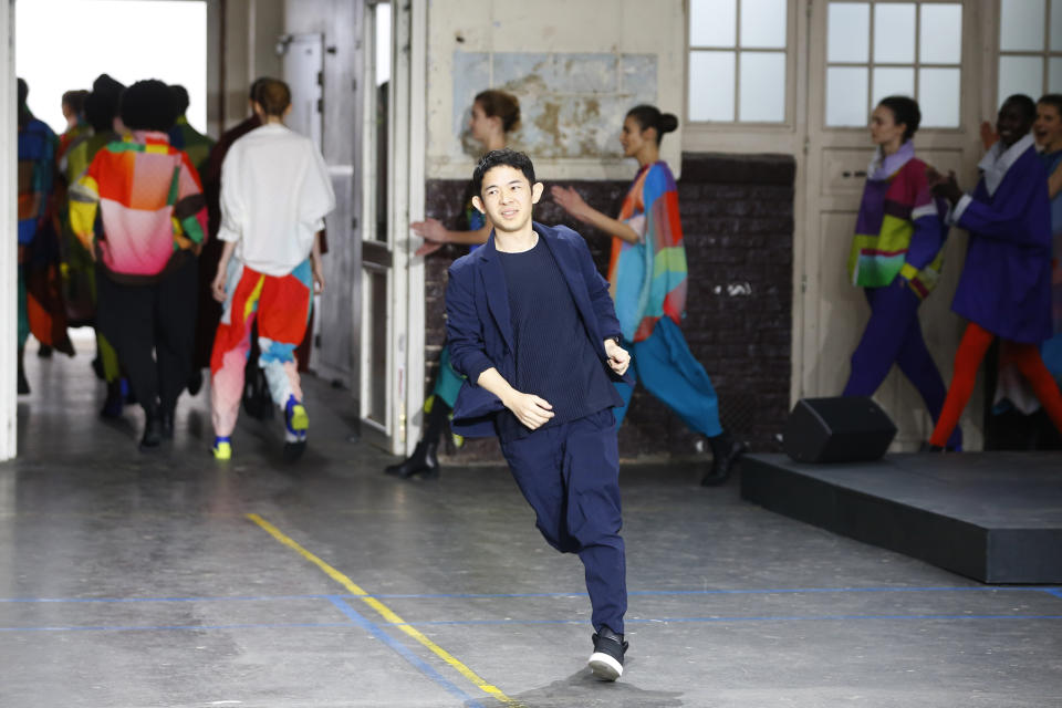 Designer Yoshiyuki Miyamae accepts applause at the conclusion of the Issey Miyake ready to wear Fall-Winter 2019-2020 collection, that was presented in Paris, Friday, March 1, 2019. (AP Photo/Michel Euler)