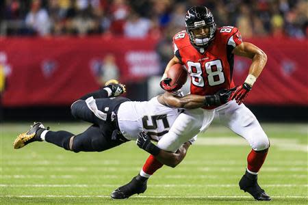 Nov 21, 2013; Atlanta, GA, USA; Atlanta Falcons tight end Tony Gonzalez (88) is tackled by New Orleans Saints middle linebacker Curtis Lofton (50) after a catch in the second half at the Georgia Dome. The Saints won 17-13. Mandatory Credit: Daniel Shirey-USA TODAY Sports