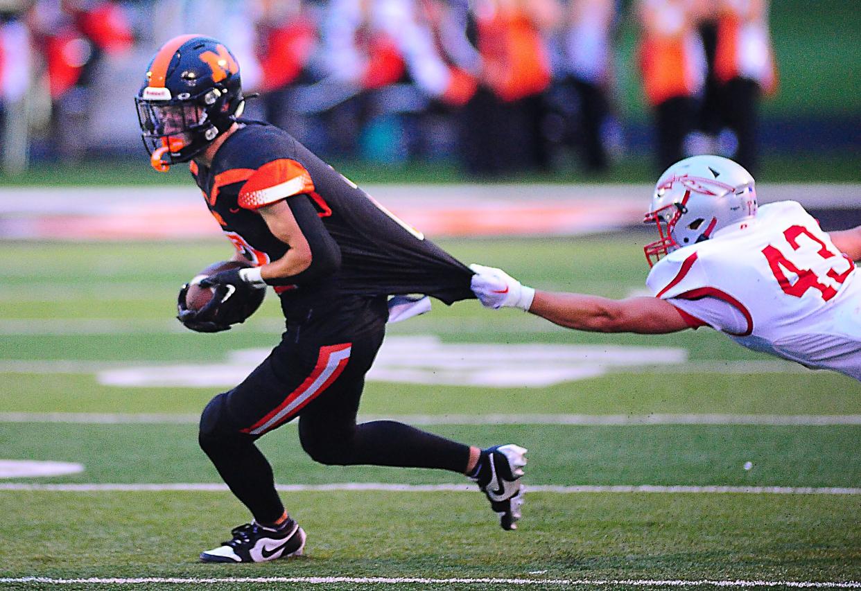 Marlington's Beau Himmelheber breaks free from the grasp of Northwest defender Parker Kraft, Friday, Aug. 25, 2023.