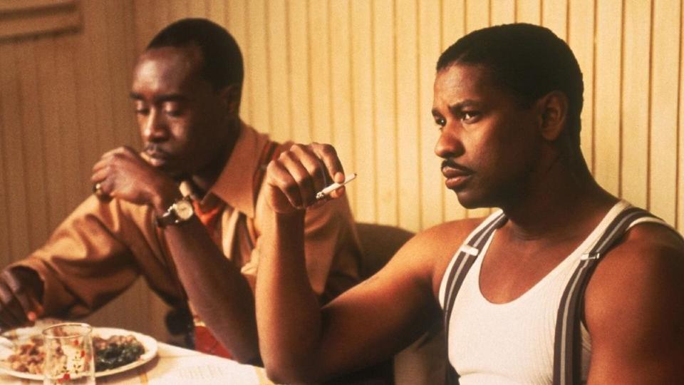 Don Cheadle and Denzel Washington sitting at a table