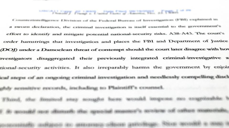 A page from the Justice Department's motion to the 11th Circuit U.S. Court of Appeals in Atlanta is photographed Friday, Sept. 16, 2022. The Justice Department asked the federal appeals court to lift a judge's order that temporarily barred it from reviewing a batch of classified documents seized during an FBI search of former President Donald Trump's Florida home last month. (AP Photo/Jon Elswick)