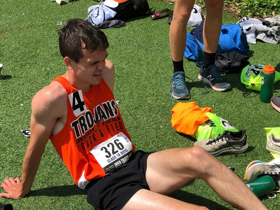 Elmwood High School anchor man Thomas Harmon recovers near the infield after helping the Trojans to a second-place finish in the 4-x-800 relay at the IHSA Class 1A State Track and field boys championships at Eastern Illinois University on Saturday, May 28, 2022.