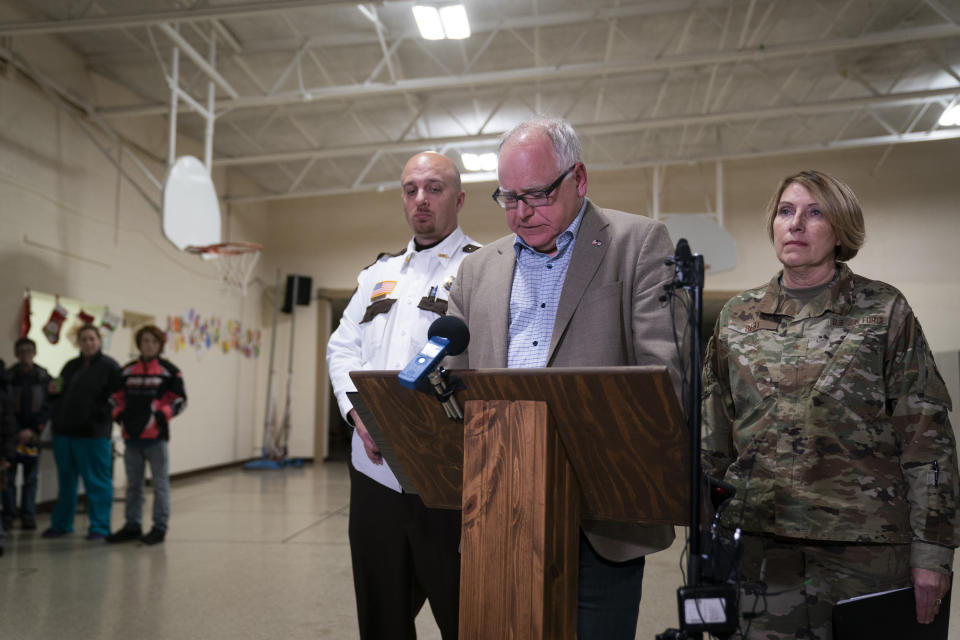 Gov. Tim Walz speaks during a news conference, Thursday, Dec. 5, 2019 in Marty, Minn. At left is Chief Deputy Dan Miller and at right is Brig. Gen. Sandy Best. A Black Hawk helicopter with three crew members aboard crashed Thursday in central Minnesota, the Minnesota National Guard said, though officials did not offer any immediate information about the conditions of crew members. (Renee Jones Schneider/Star Tribune via AP)