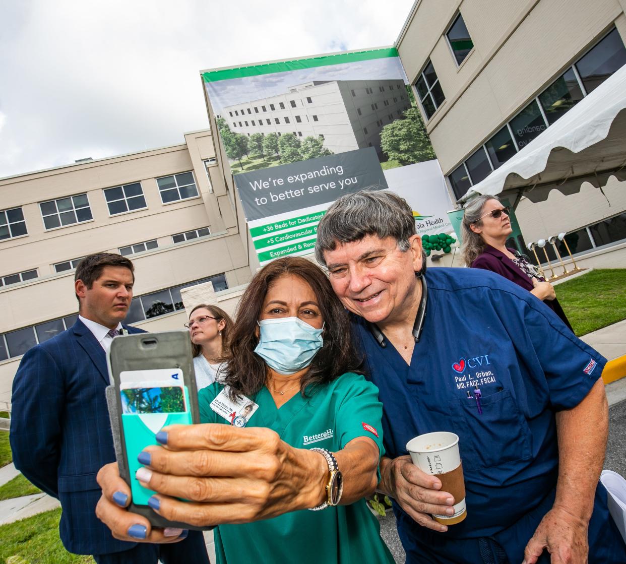 Registered Nurse Sonia Torres, left, takes a picture of herself and Cardiologist Dr. Paul Urban, right, during Ocala Health's ground breaking at the Ocala Regional Medical Center Tuesday morning, June 29, for the Ocala Health Neuro ICU and CV Procedural Suites. The facility will create 36 beds and five cardiovascular procedure suites at a cost of $65 million.