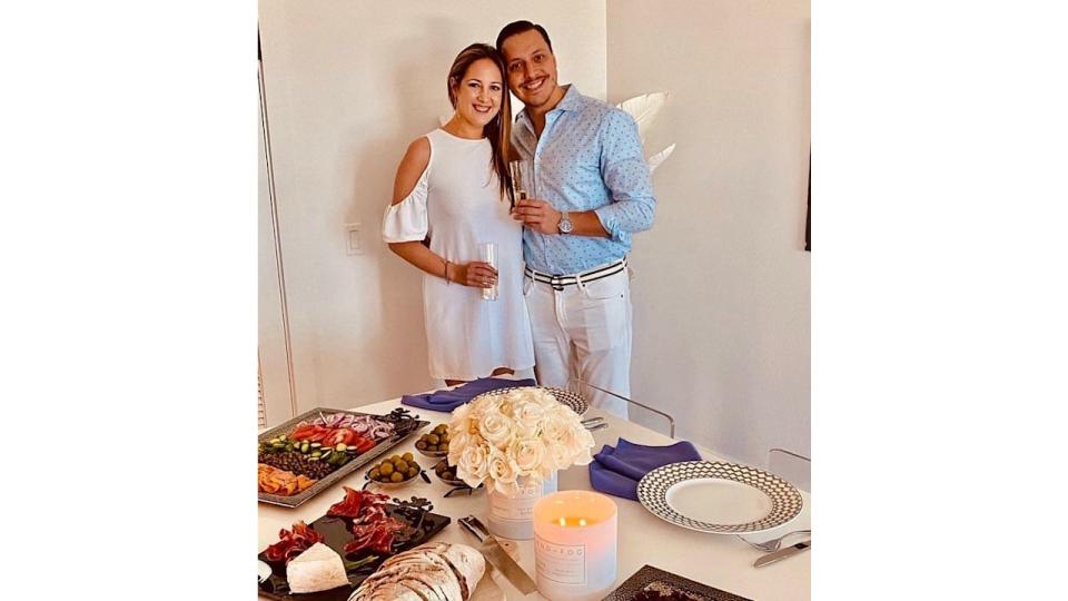 Princess Theodora and Matthew in front of a table of food