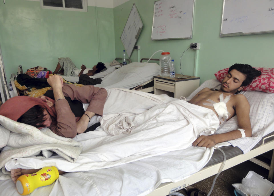 Wounded Afghans lie on a bed at a hospital after fighting between Taliban and Afghan security forces in Kandahar province south of Kabul, Afghanistan, Thursday, Aug. 5, 2021. (AP Photo/Sidiqullah Khan)